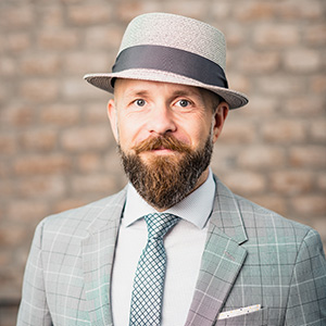 Man wearing grey hat and grey suit