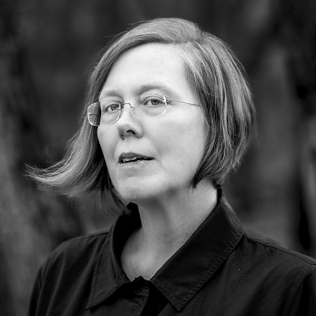 woman with chin-length hair wearing glasses