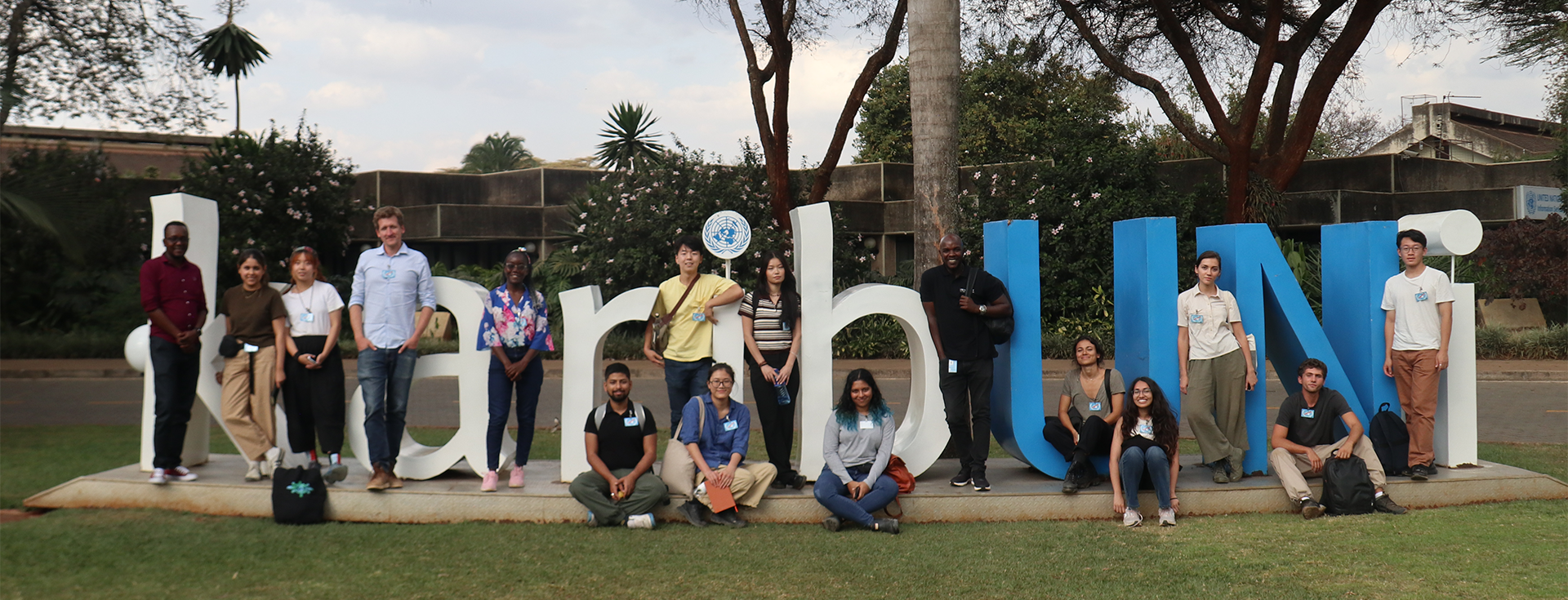 people standing in front of a sculpture