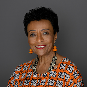 a woman with short black hair and earrings