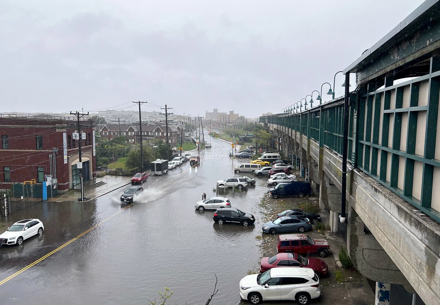 Cars parked along a flooded road