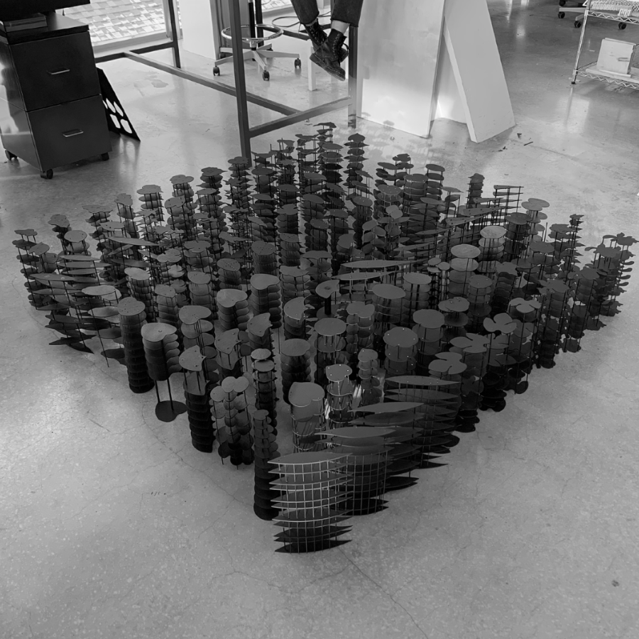 A collection of architectural sculptures sitting on the ground in a group formation.