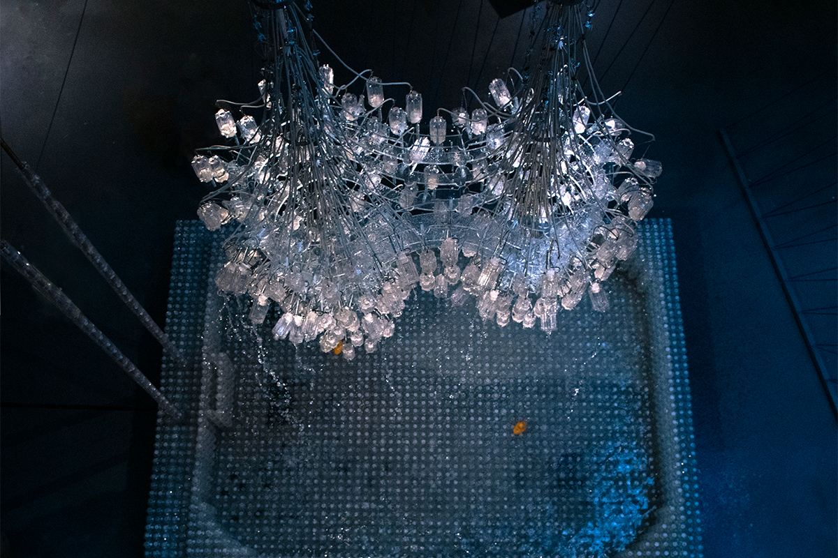 Aerial view of chandelier suspended over a pool of water.
