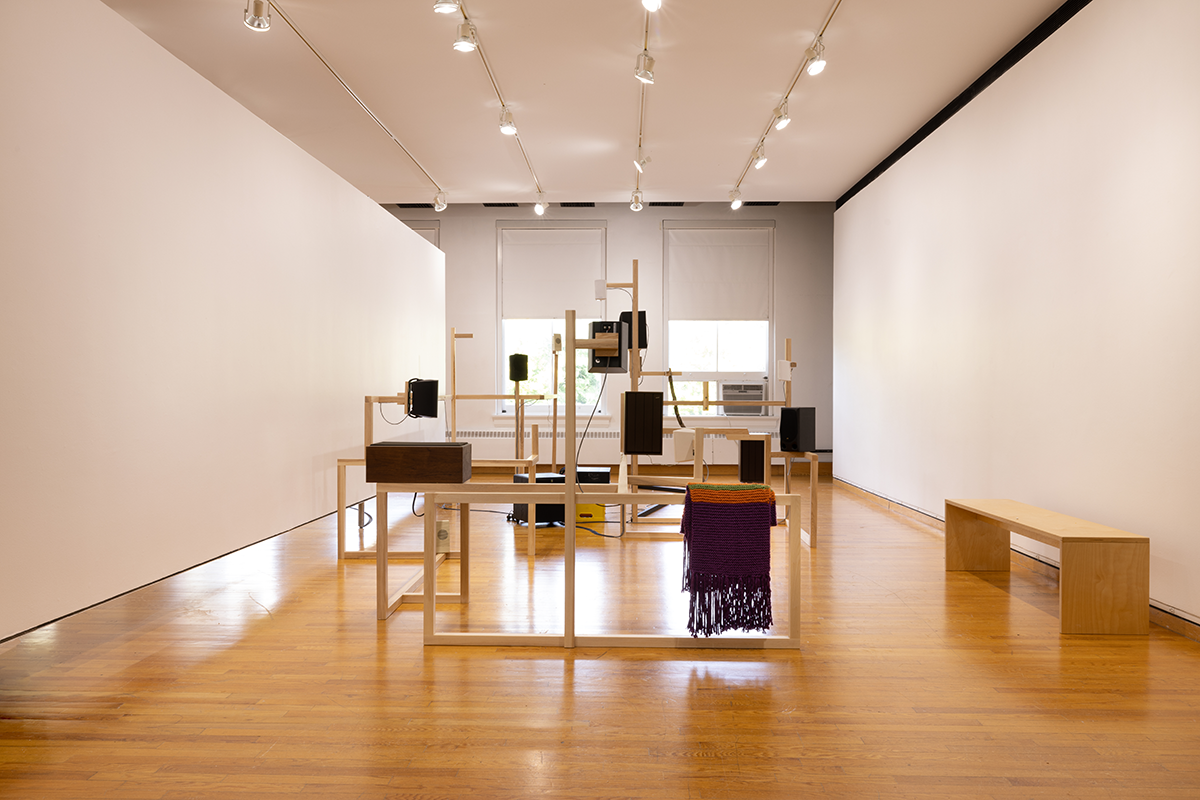 Gallery space with speakers mounted at various heights