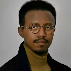 A man wearing glasses looking serious