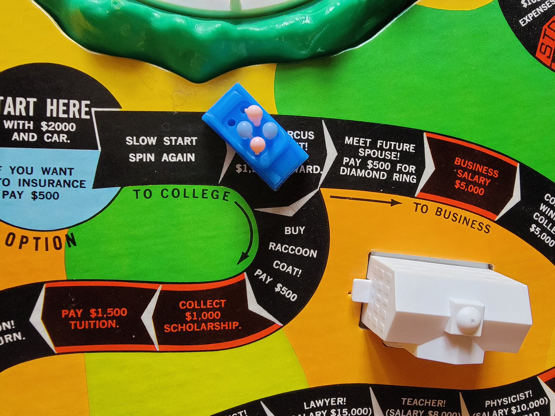 Overhead view of a board game with plastic pieces set out on it.