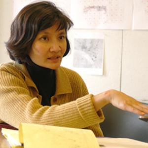 A woman with short black hair teaching