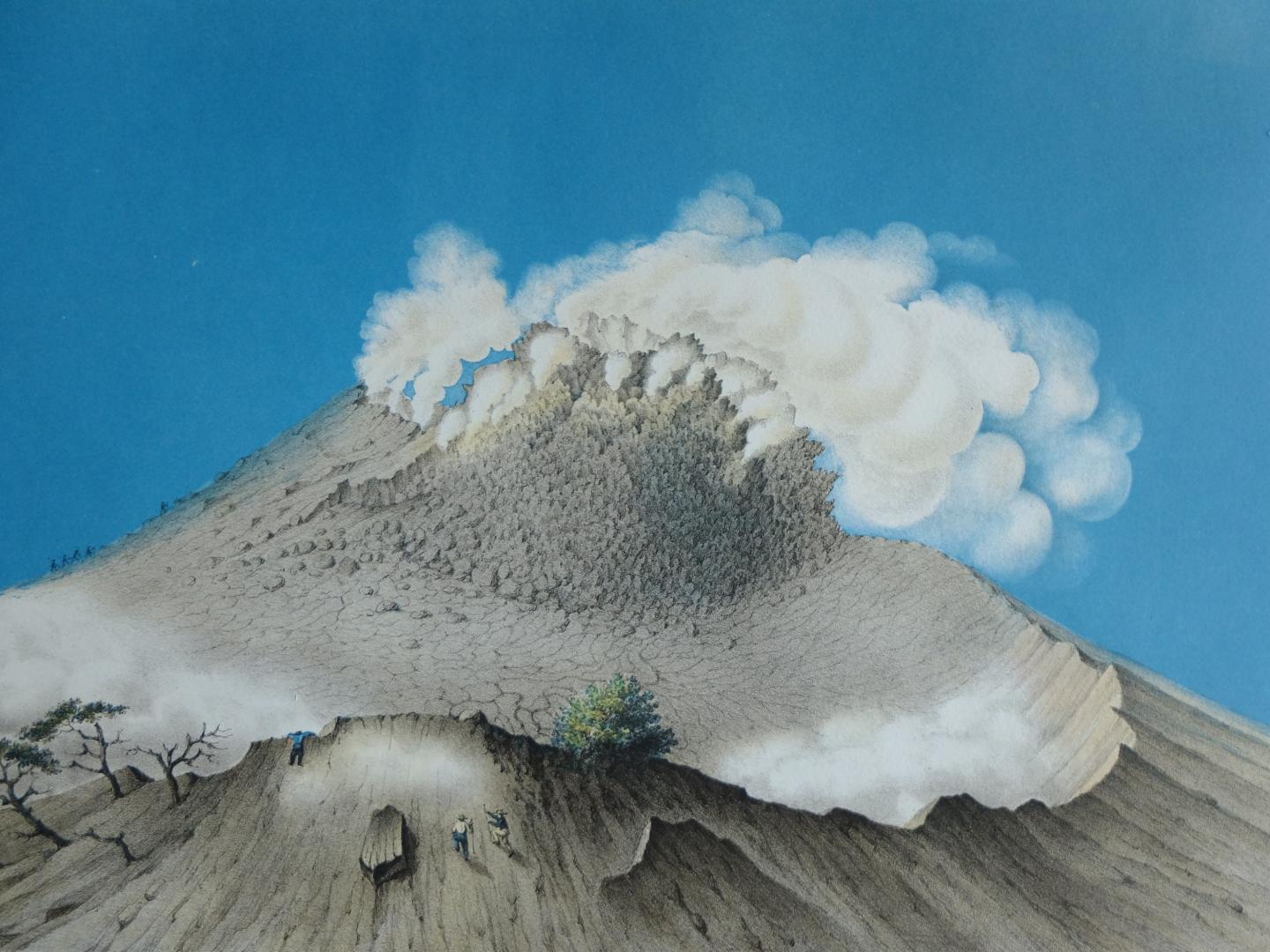 the top of a volcano spews ash, two figures below point near dead trees, against a blue sky