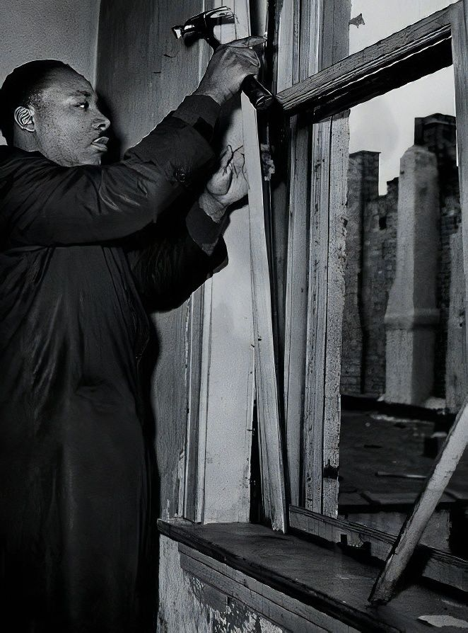 Dr. Martin Luther King Jr. repairing a window in his apartment in Chicago.