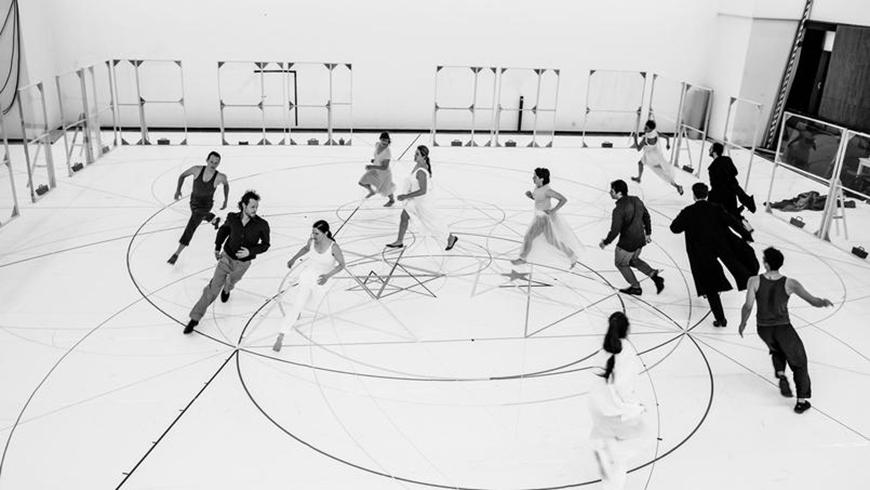 people running in circles on a white floor marked with circular diagrams