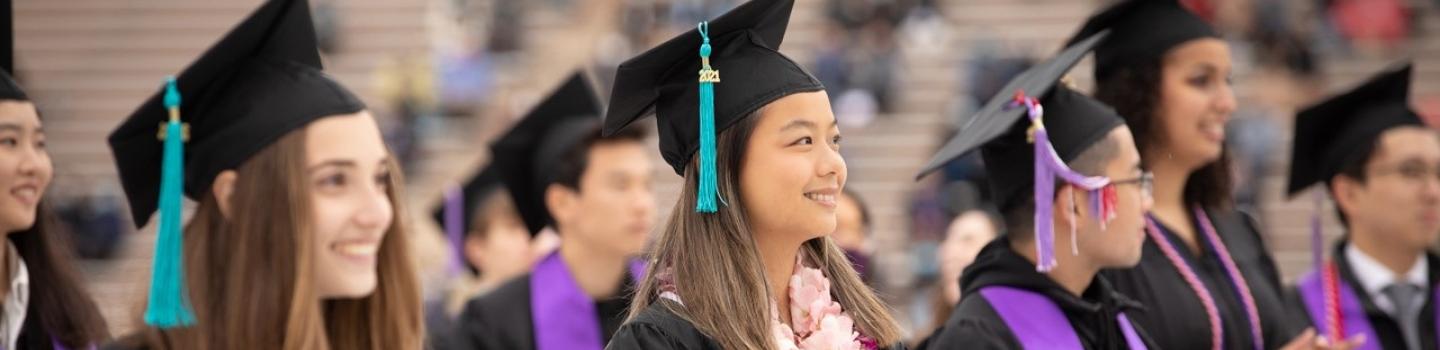 Students wearing their caps and gowns at a graduation ceremony.