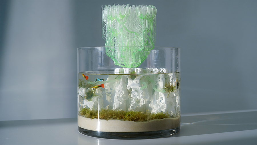 A fish bowl with a translucent green structure protruding from the top.
