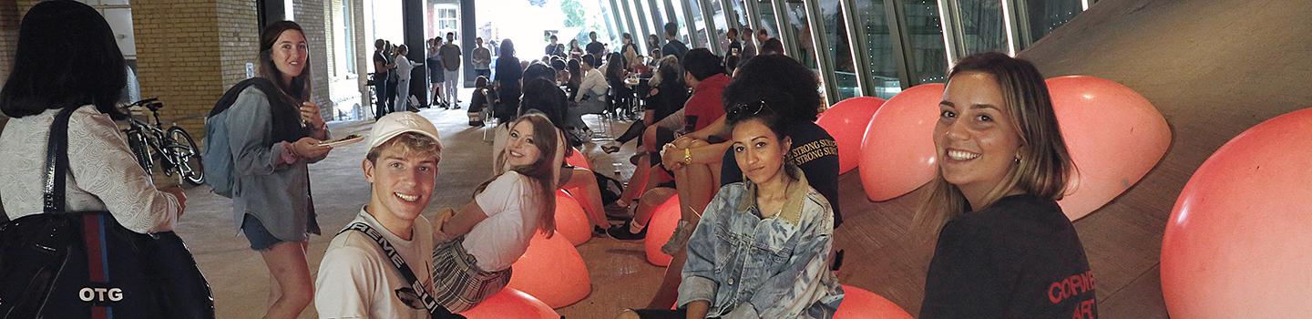 Students sitting on the LED bubbles in the arcade between Milstein and Sibley halls.