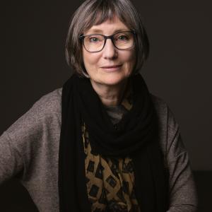 a person weraing glasses and a scarf