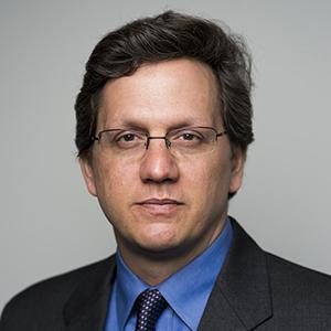 man wearing glasses and a suit and tie