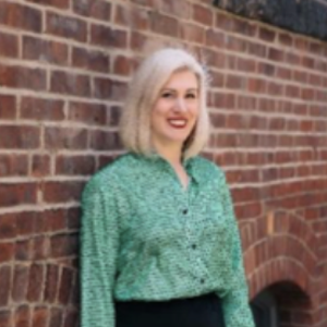 woman with light hair and green shirt