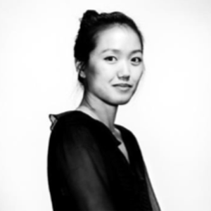 woman with dark hair and a dark blouse