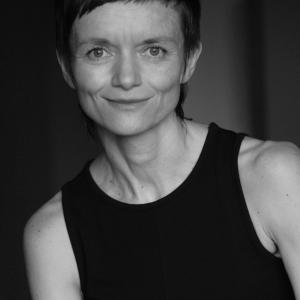 Black and white photo of a woman with short hair wearing a black tank top