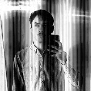 Black and white image of a man with dark colored hair and mustache, wearing a button up collared shirt