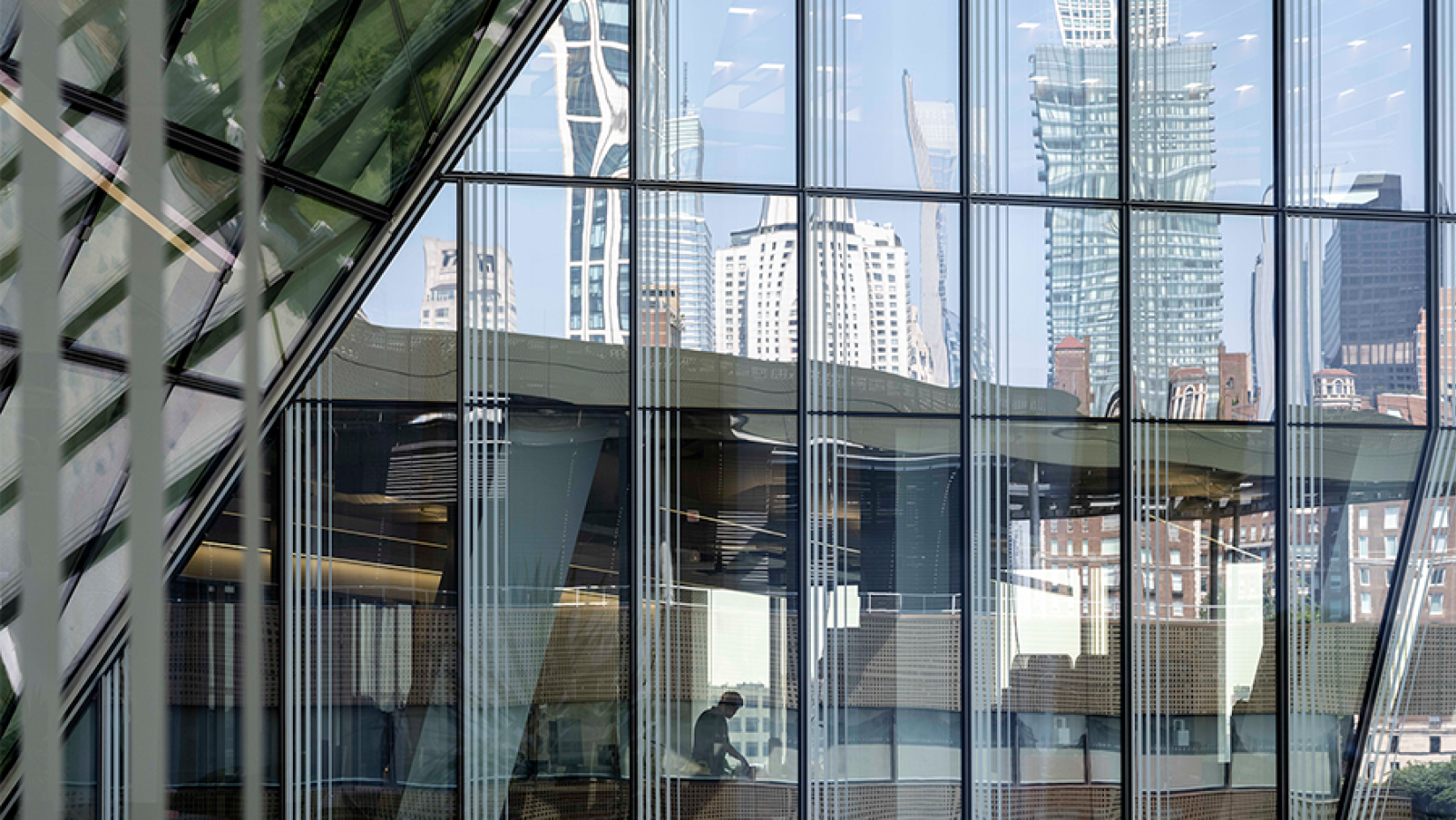 NYC skyline reflected by glass building