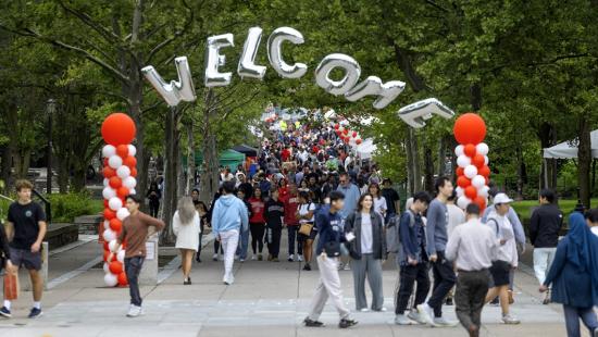 Cornell students walk on campus in Ithaca, NY.
