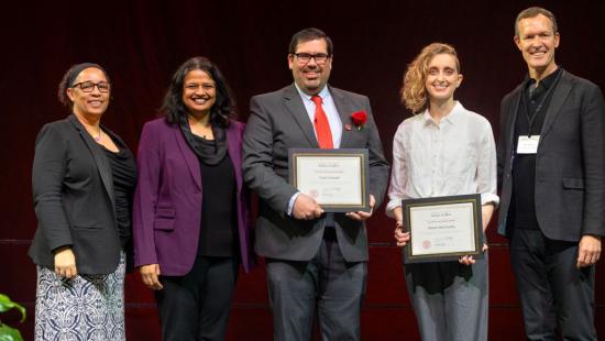 5 people standing for a group phtoto holding awards and smiling.