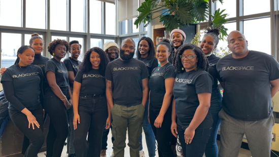Group of Black men and women all wearing black tshirts that read BLACKSPACE