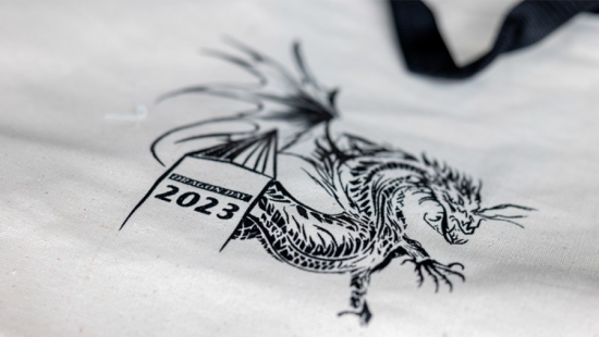 White canvas tote with black illustrated dragon