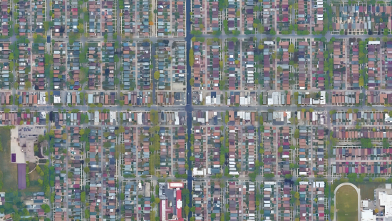 Rows of houses and buildings surrounded by streets and grass.