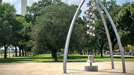 Metal bells hung from a large metal tripod