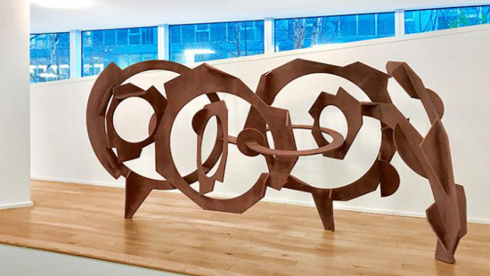 Large steel sculpture on display in a gallery space.