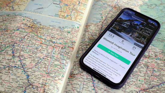 cellphone placed on top of a paper map