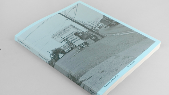 Black and white image of a truck stop printed on a light blue book caver
