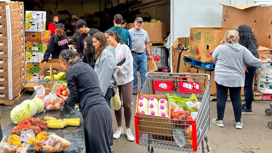 People gathered outside distributing food supplies.