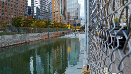 flooded urban underpass with skyscrapers at back