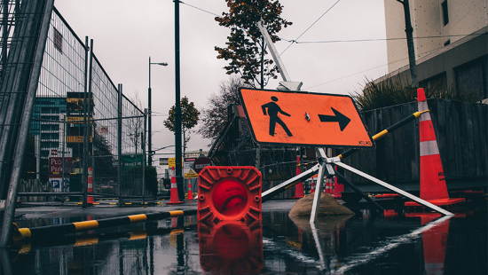 Submerged neon orange signs on a flooded street