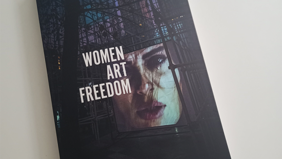 A top doen image of a book cover that reads Women, Art, Freedom.