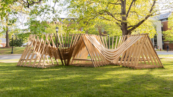 A wooden structure on a green lawn