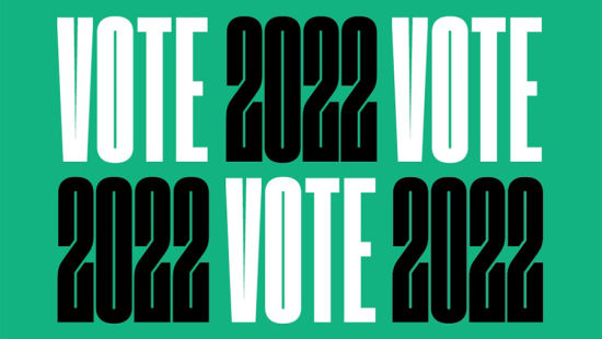 White and black text stating Vote 2022 on green background 