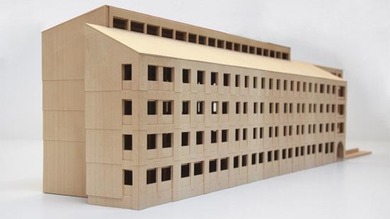 A four-story multi-unit residence modeled in brown wood.