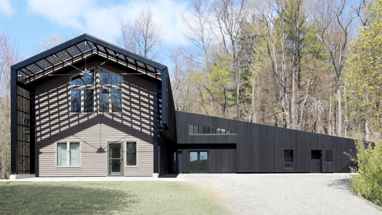 A gabled building with slanting shadows and sloped roof.