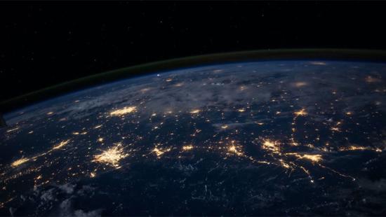 View of earth from space with city lights visible