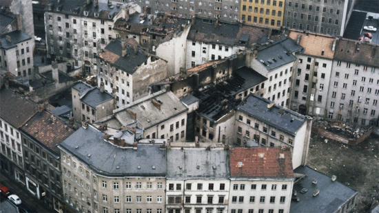 Older, concrete multi-story apartment buildings in states of disrepair.