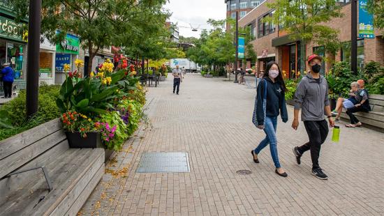 People and storefronts on a pedestrian mall.