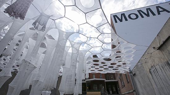 woven white structures creating a canopy in a courtyard