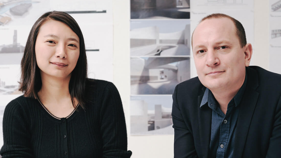 Man and woman wearing black and looking at the camera