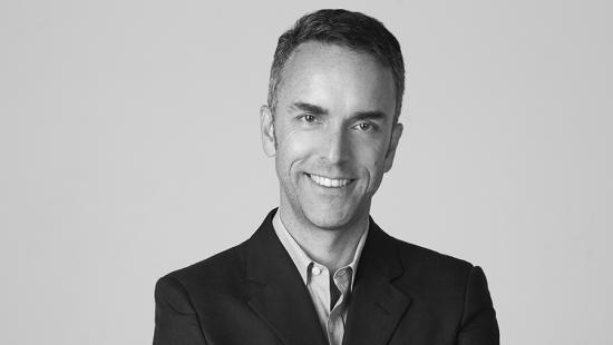 a man smiling in a black jacket