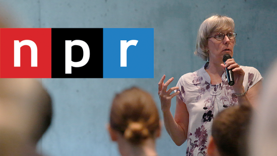 Person speaking into a microphone in front of an audience, National Public Radio logo superimposed