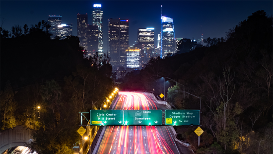Aerial view of a Los Angeles highway looking towards the city at night