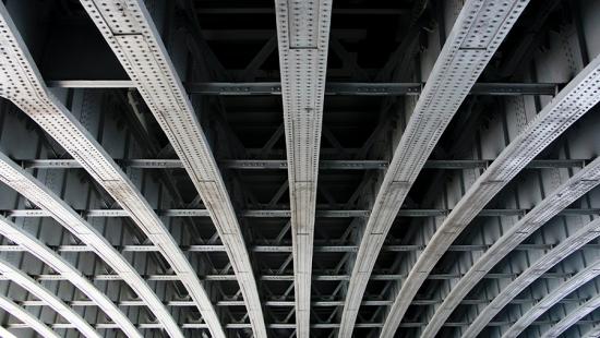 Steel girders and rivets overhead.